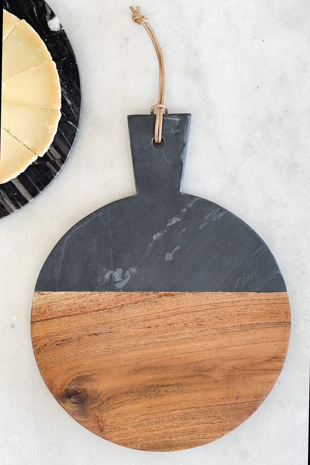 Detalle Tabla Redonda De Mármol Negra Y Madera Con Mango Cristina Oria 