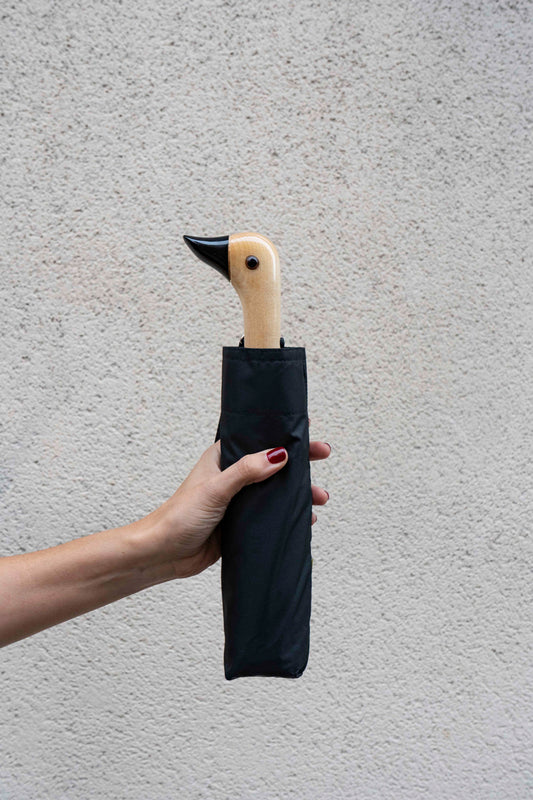 Guarda-chuva com design preto e pega em forma de cabeça de pato